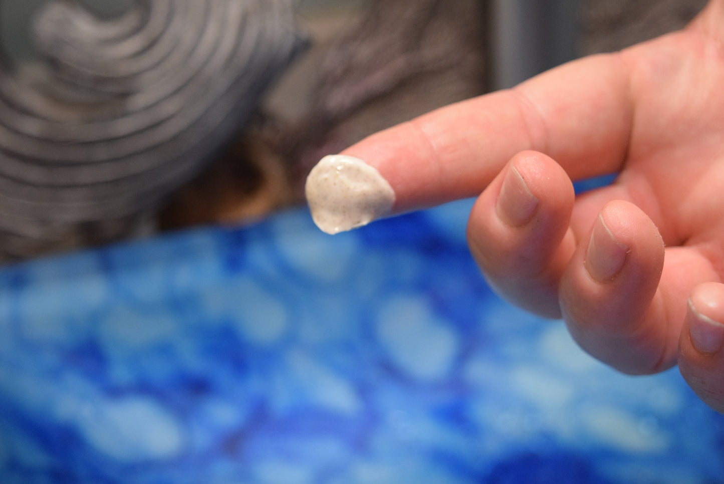 Finger with dab of Amber Face scrub on finger tip, Apothecuryous