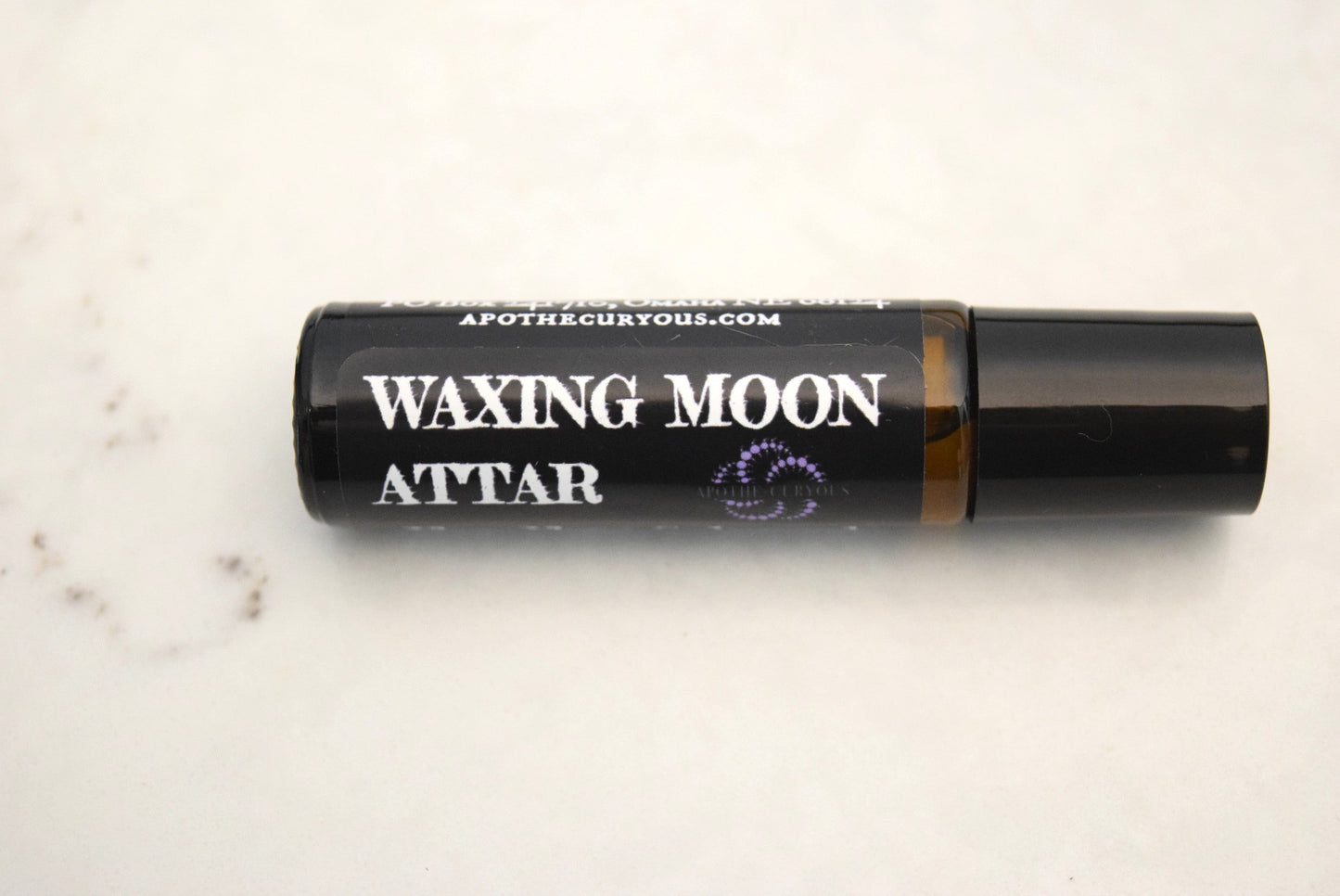 Waxing Moon Attar in amber glass roller bottle