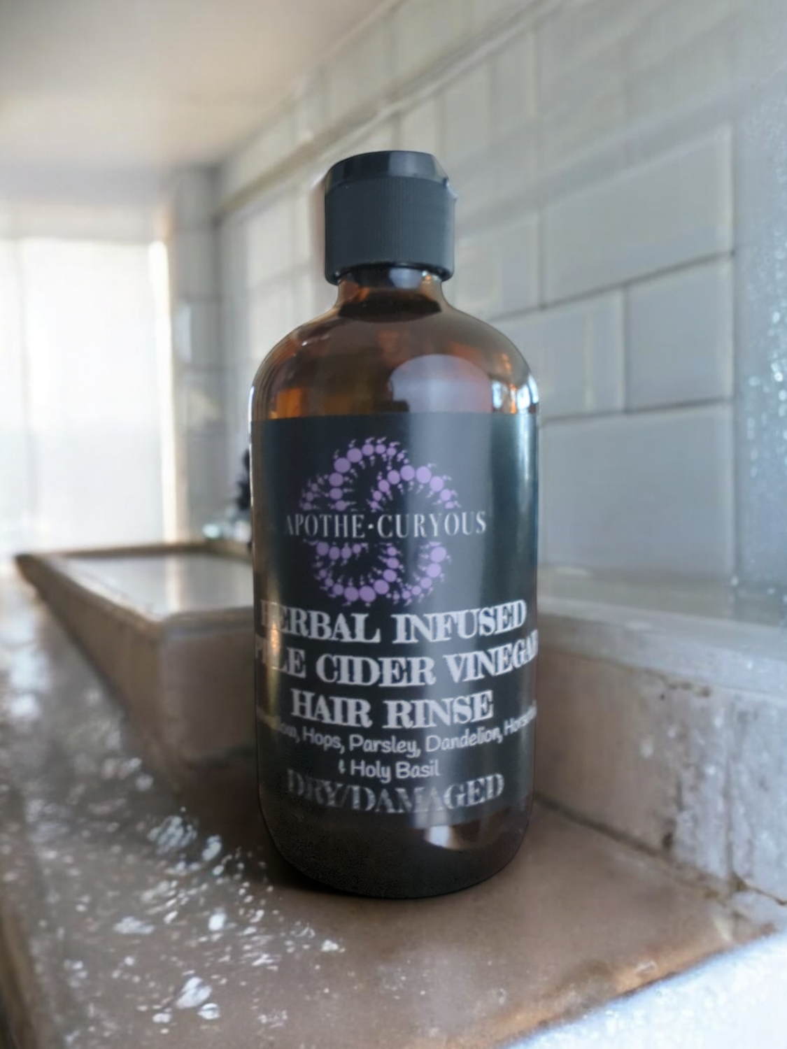 Herbal infused ACV rinse in glass bottle