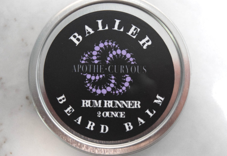 Close up of aluminum tin of Baller Beard Balm, Rum Runner scent. Apothecuryous