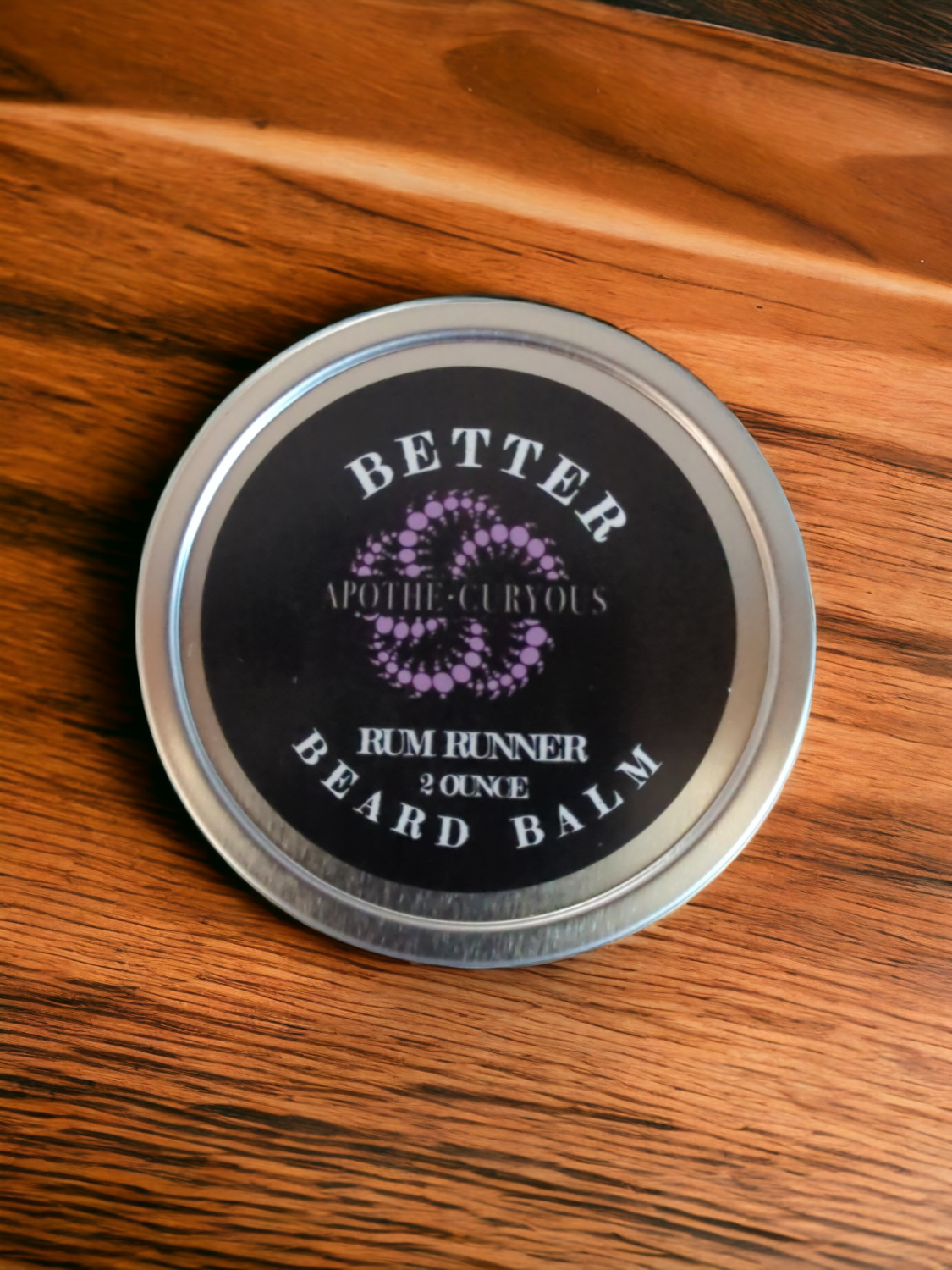 Better Beard Balm in aluminum tin on wood surface, Apothecuryous