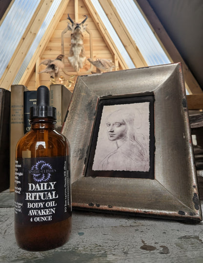 Bottle of 'Daily Ritual Body Oil' with a rustic background featuring a framed portrait and wooden architecture.
