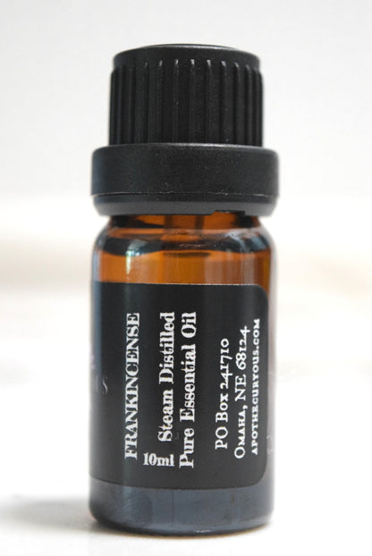 A 10ml amber glass bottle of Frankincense Steam Distilled Pure Essential Oil with a black ribbed cap and a black label, shown against a plain white background.