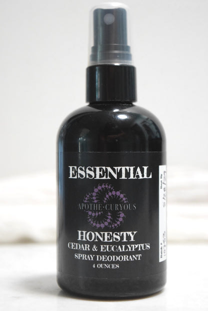 A 4-ounce black spray bottle of ApotheCuryous Honesty Cedar & Eucalyptus Natural Spray Deodorant