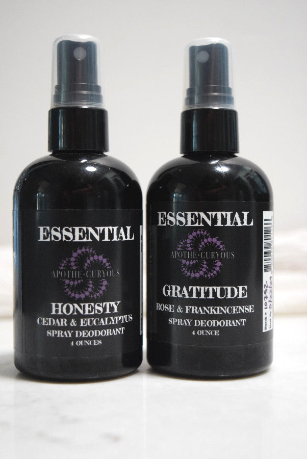 Black plastic bottles of 2 varieties of Essential spray deodorant, Apothecuryous