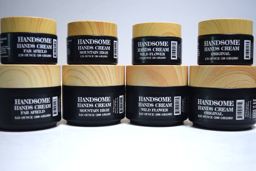 Multiple jars of Handsome Hands Cream stacked on a white background
