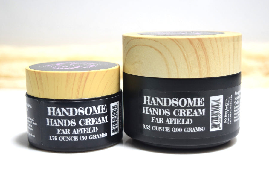 Two jars of 'HANDSOME HANDS CREAM FAR AFIELD' on a light background