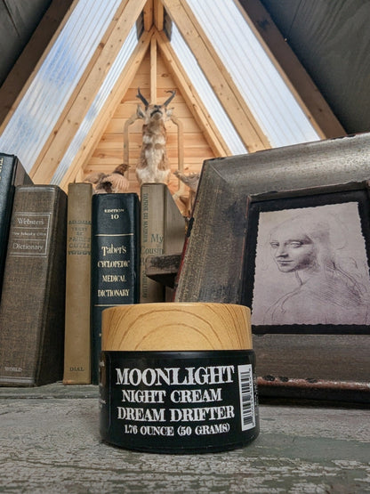 Moonlight Night Cream container with a rustic background featuring books and a framed picture.