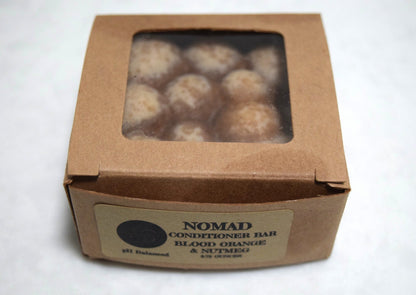 Nomad conditioner bar in brown kraft paper box with window.  Apothecuryous