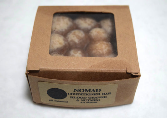 Nomad conditioner bar in brown kraft paper box with window.  Apothecuryous