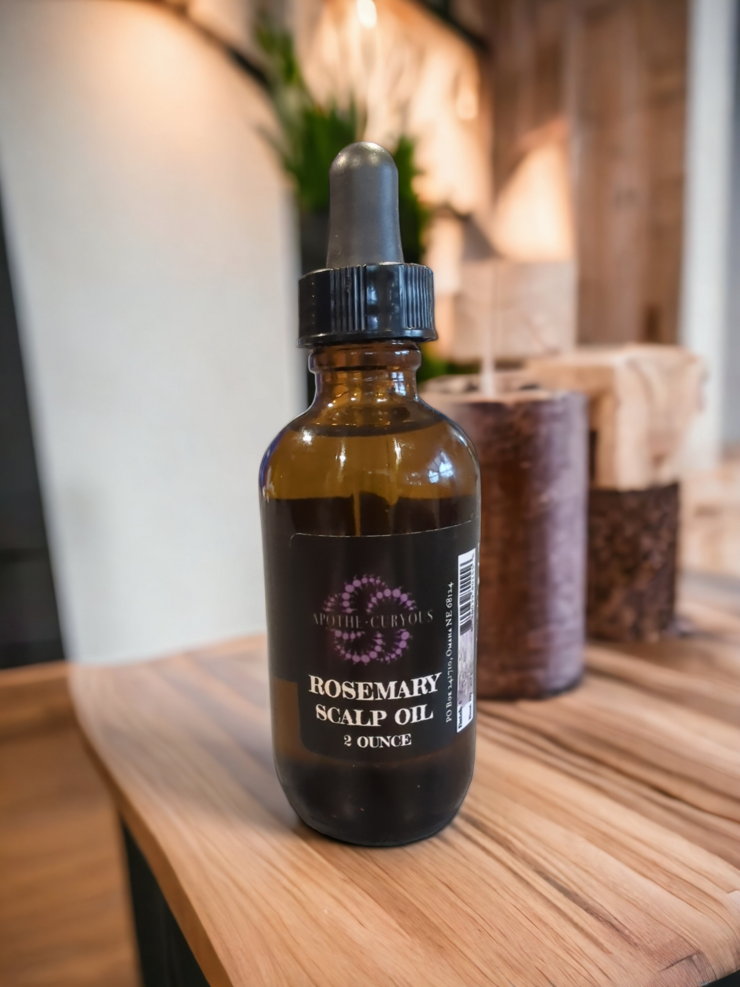 Rosemary scalp oil on counter, 2 ounce glass bottle with dropper top, Apothecuryous