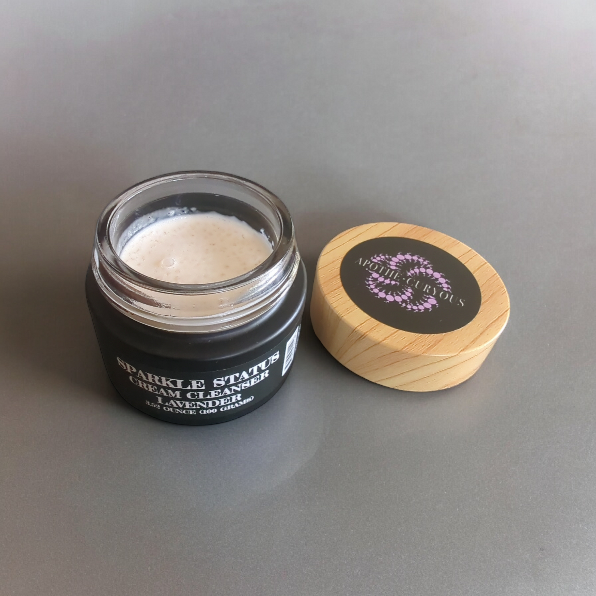 Sparkle Status cream cleanser lid off, black glass jar, Apothecuryous