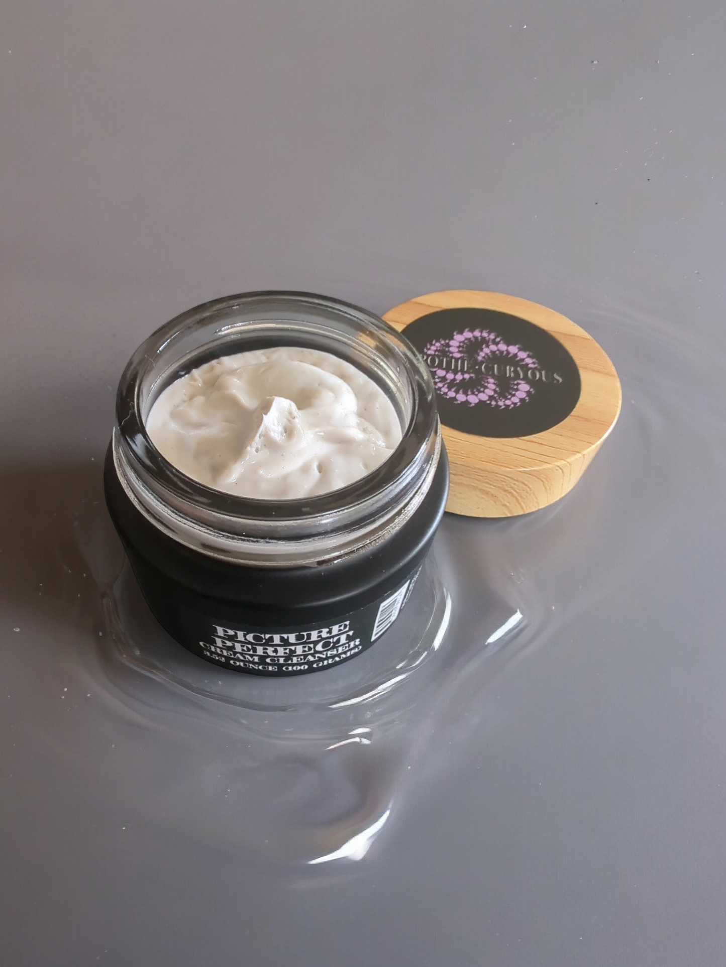 Picture Perfect cream cleanser in a black glass jar, lid off, Apothecuryous