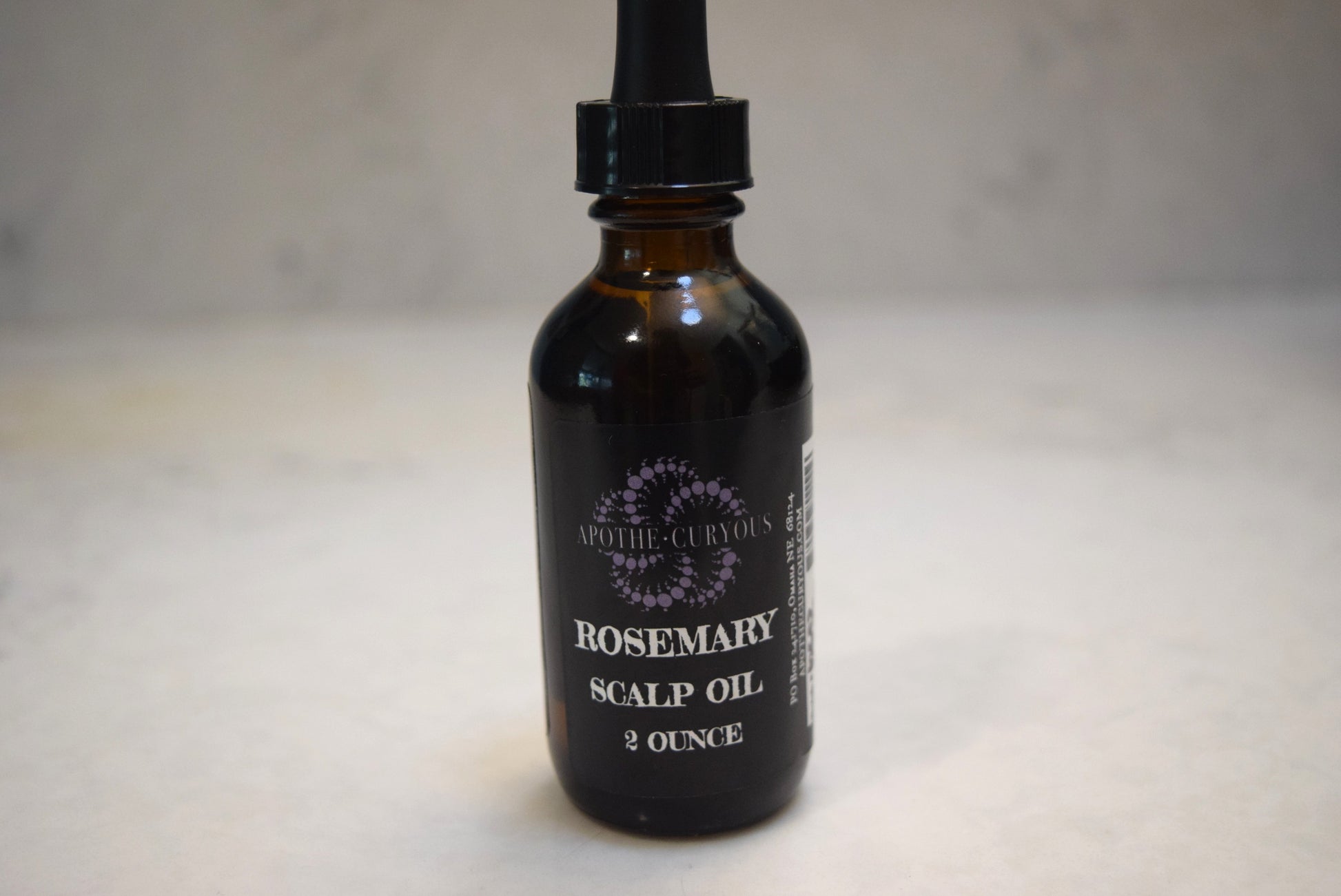 Rosemary scalp oil in amber glass bottle with dropper top, Apothecuryous