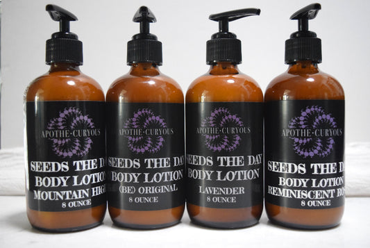 Four amber glass pump bottles of Apothecuryous Seeds the Day Body Lotion arranged in a row against a light gray background.