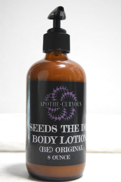 An 8-ounce amber glass bottle of body lotion with a black pump dispenser and a black label. 'SEEDS THE DAY BODY LOTION (BE) ORIGINAL'. Apothecuryous