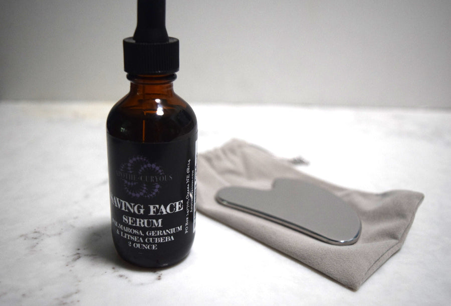 Amber glass bottle of scented face serum with Guasha massage tool and storage bag, Apothecuryous