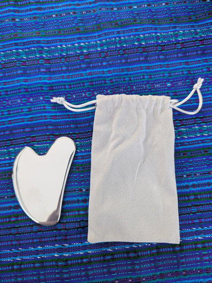 Stainless Steel Guasha next to drawstring storage bag, Apothecuryous